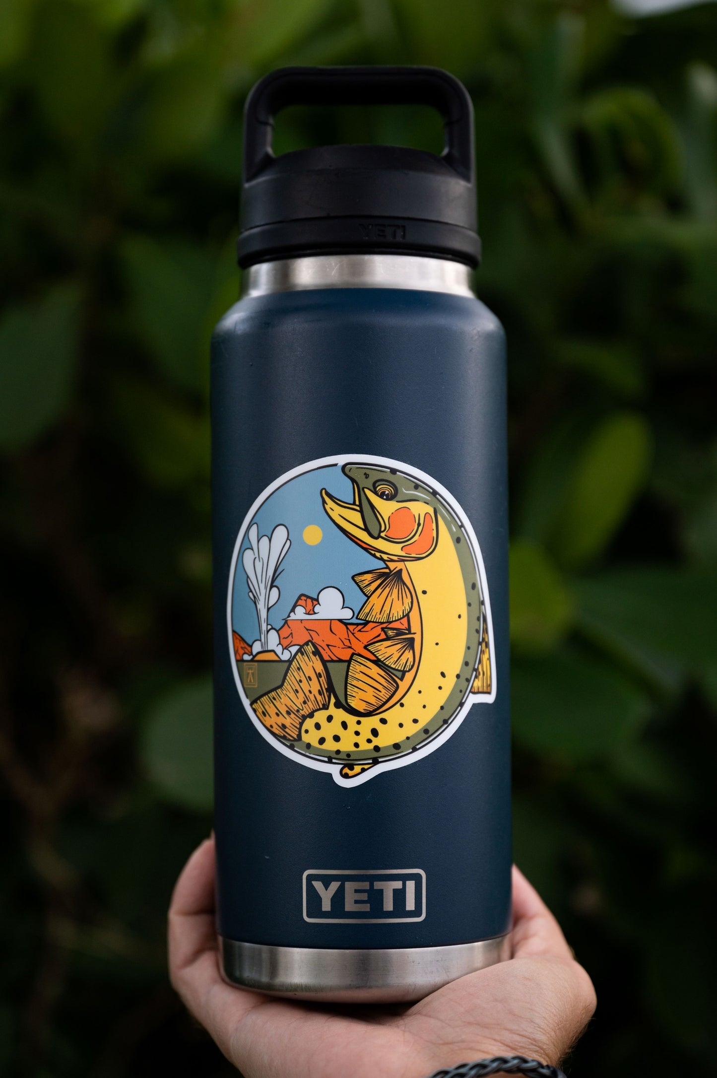 Circular sticker featuring a cutthroat trout on a Yeti tumbler