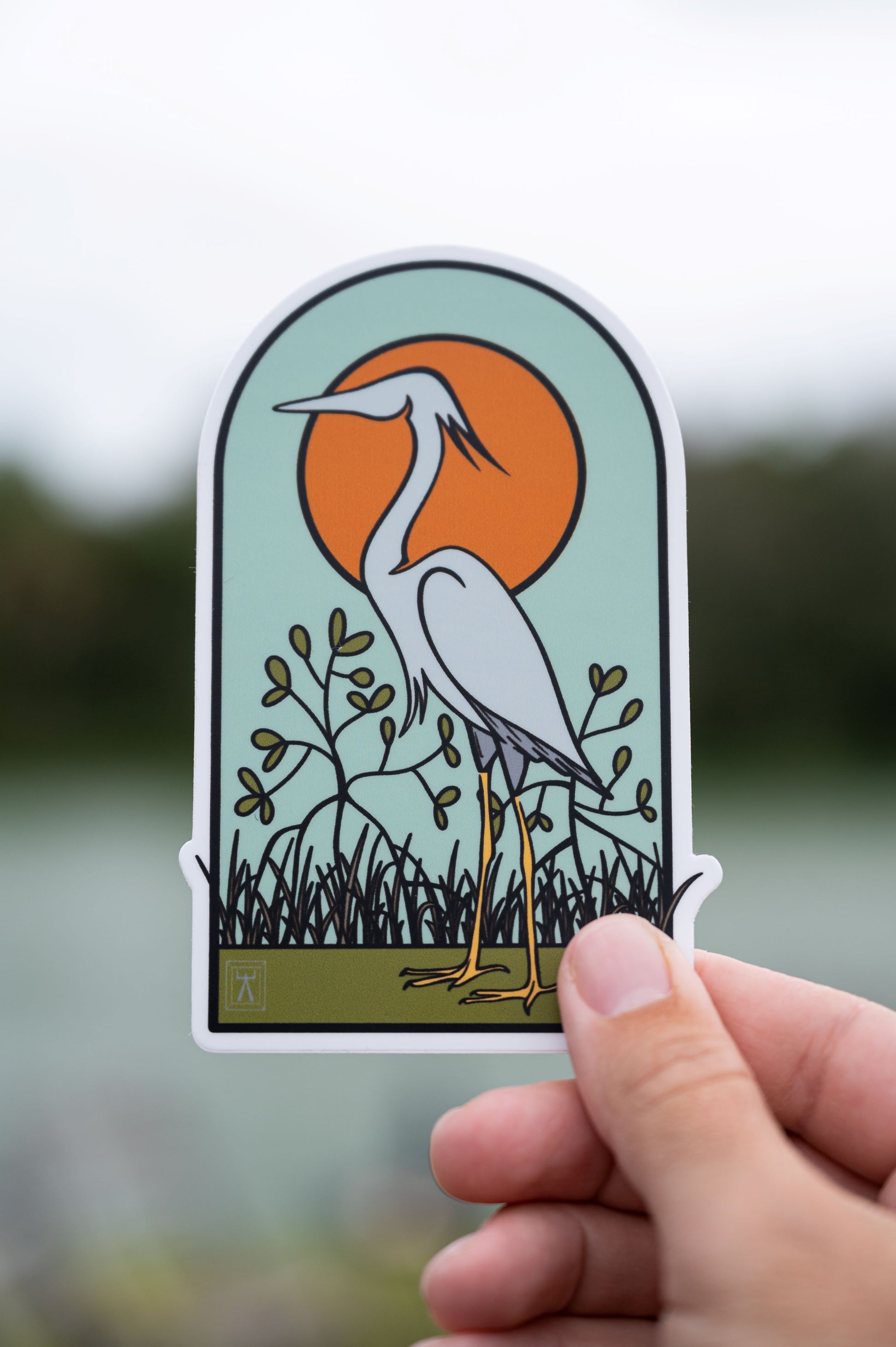 Hand holding heron backcountry mangrove sticker