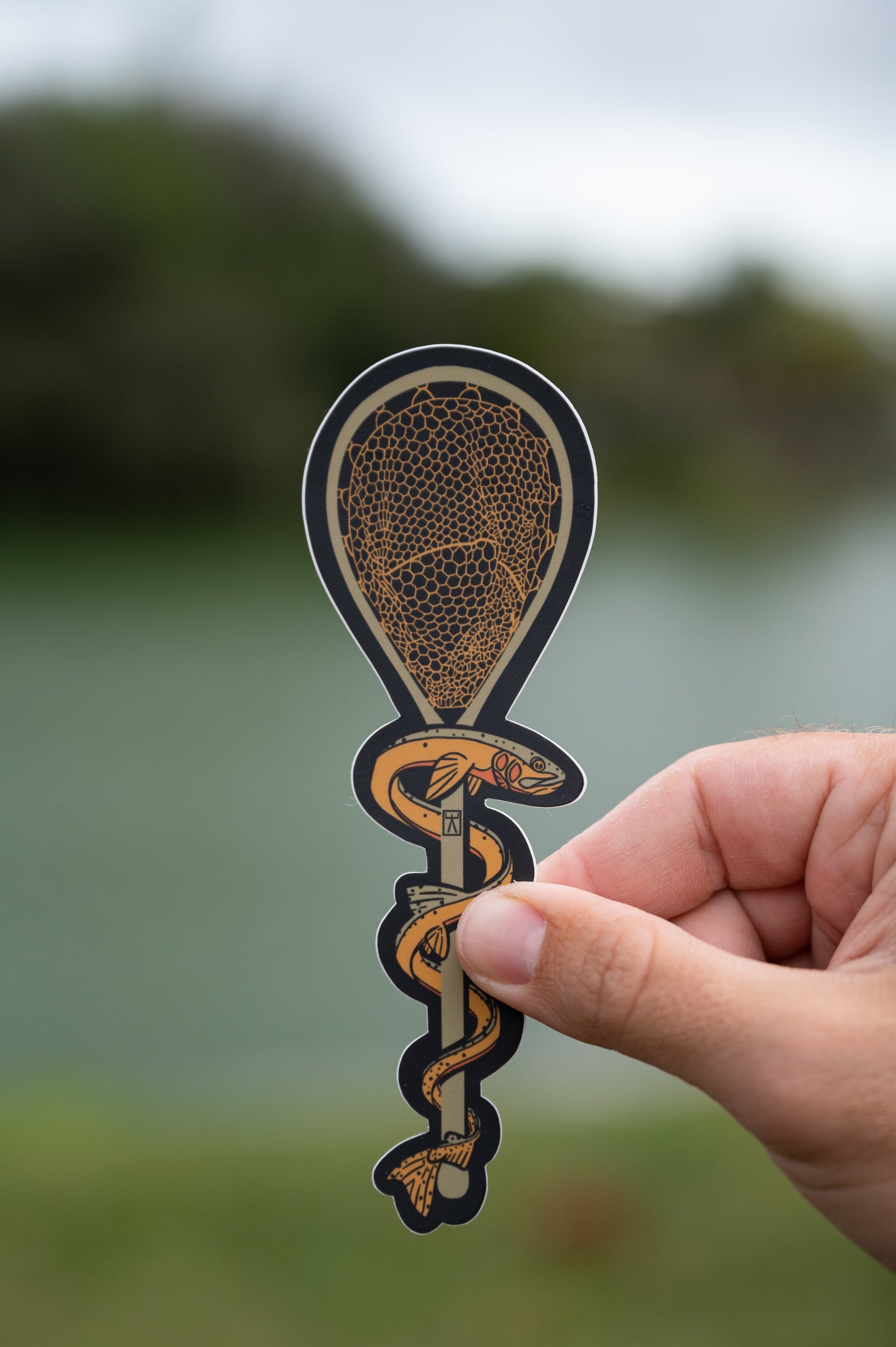 Hand holding trout therapy rod of asclepius sticker