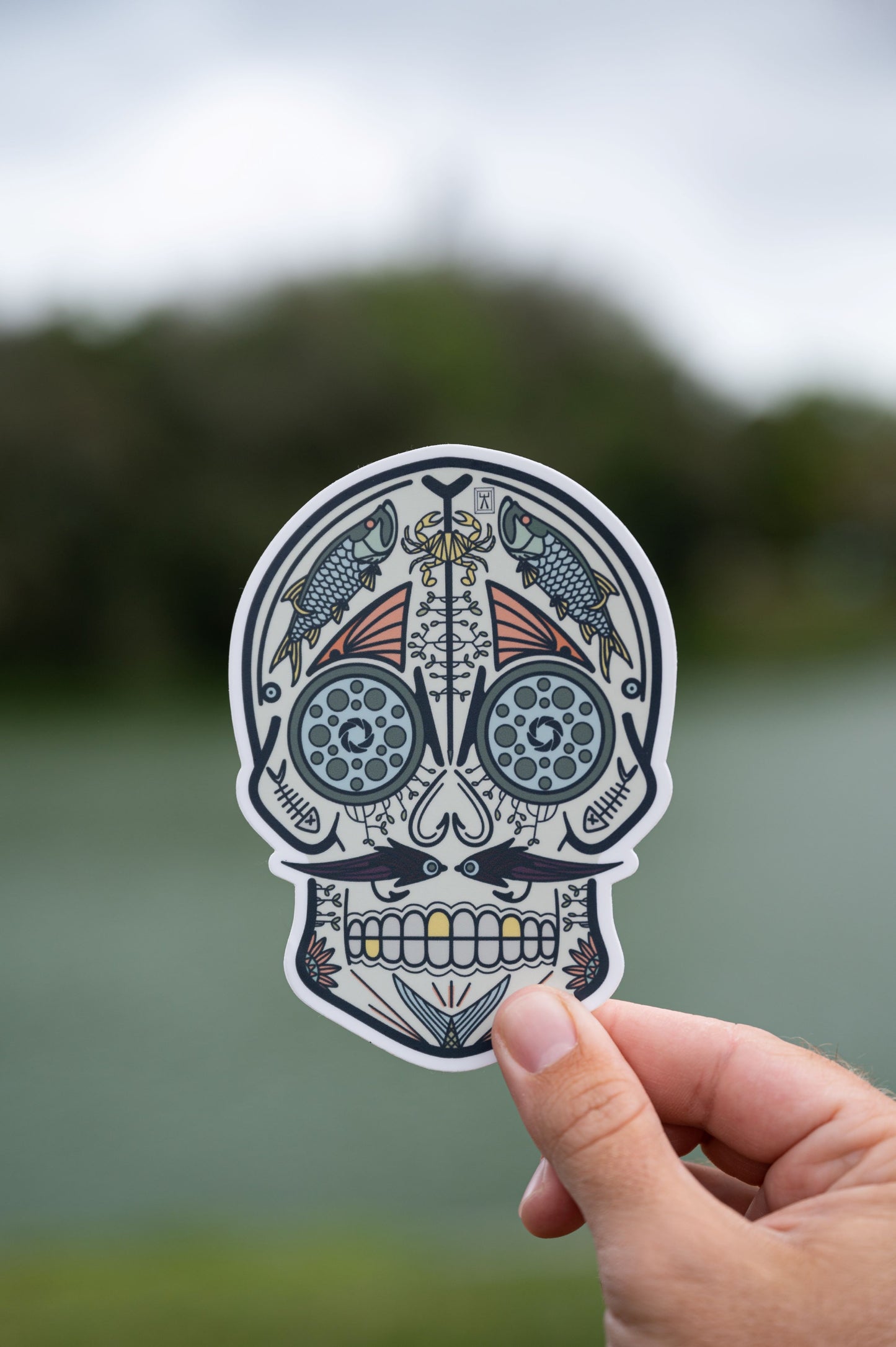 Hand holding fish Mexican sugar skull sticker